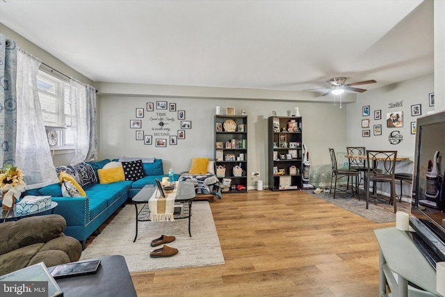 living area featuring ceiling fan and wood finished floors