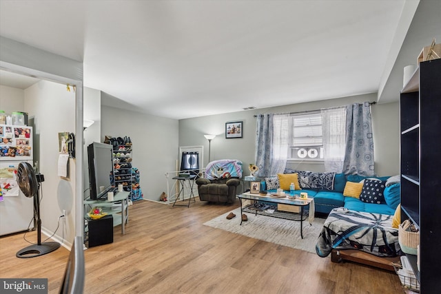 living room with visible vents and wood finished floors