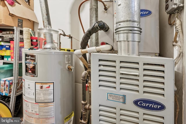 utility room featuring gas water heater and heating unit