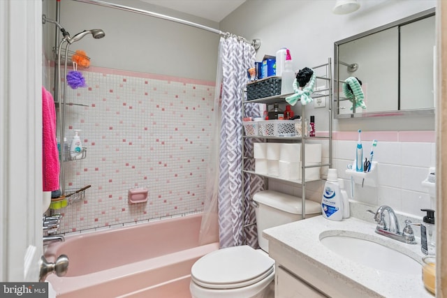 bathroom with shower / tub combo, tile walls, toilet, and vanity