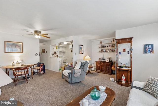 carpeted living area with a ceiling fan