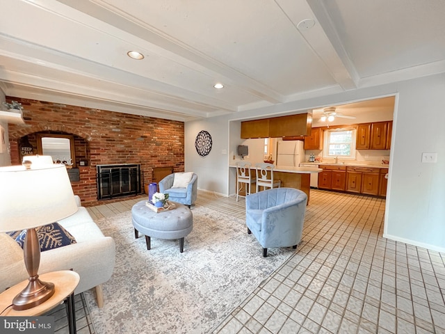 living room with a ceiling fan, baseboards, recessed lighting, a fireplace, and beamed ceiling