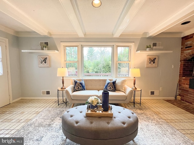 living room with tile patterned flooring, beam ceiling, and visible vents