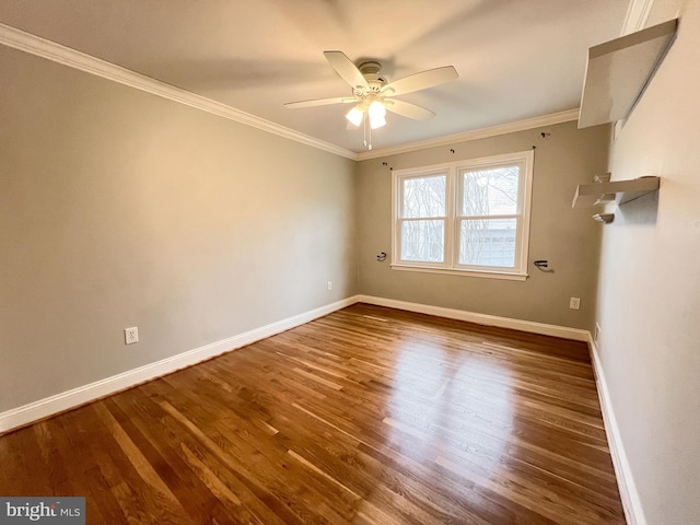 unfurnished room featuring crown molding, wood finished floors, and baseboards