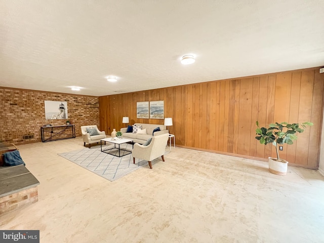 living room featuring wooden walls, brick wall, and a wood stove