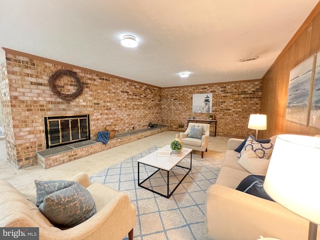 living room featuring visible vents, brick wall, a fireplace, and ornamental molding