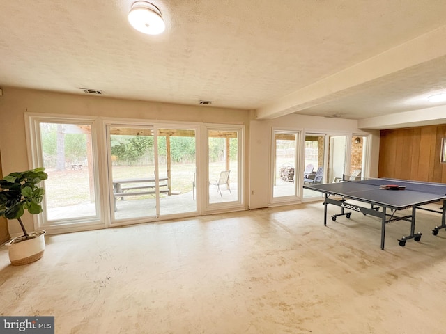 game room with visible vents, a textured ceiling, and concrete flooring