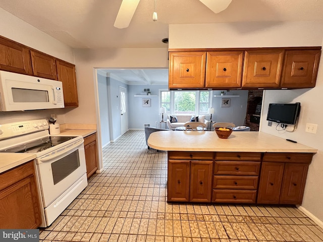 kitchen featuring brown cabinets, white appliances, and light countertops