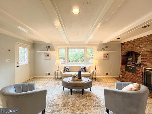 living room featuring beam ceiling, baseboards, and visible vents