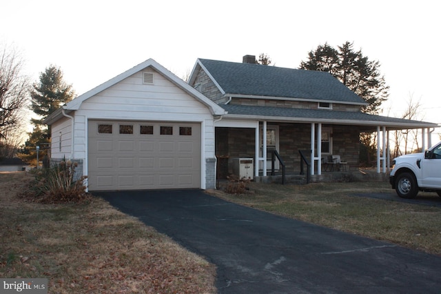 view of front facade featuring a chimney, a shingled roof, covered porch, a garage, and driveway