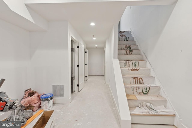 hall with stairs, unfinished concrete floors, recessed lighting, and visible vents