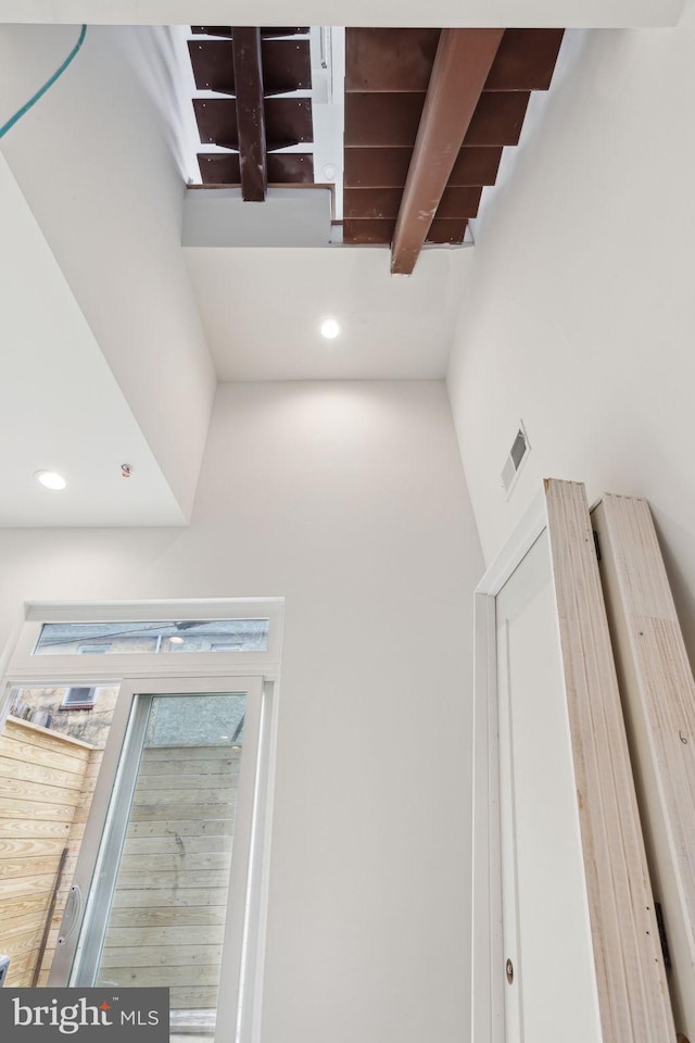 staircase with beam ceiling, visible vents, and recessed lighting