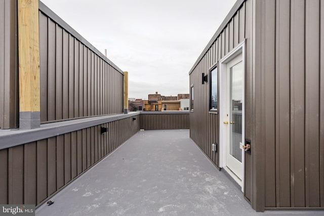 exterior space with a balcony and board and batten siding