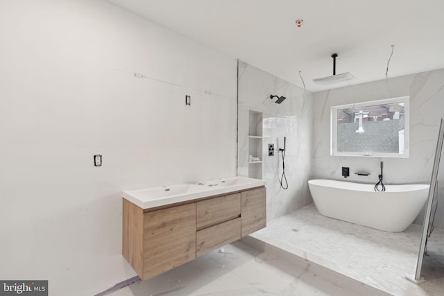 full bathroom with marble finish floor, a walk in shower, a freestanding bath, and double vanity