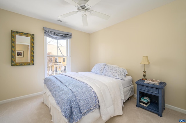 bedroom with baseboards, ceiling fan, visible vents, and light colored carpet