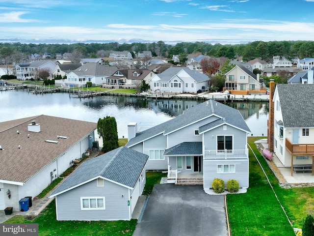 drone / aerial view with a water view and a residential view