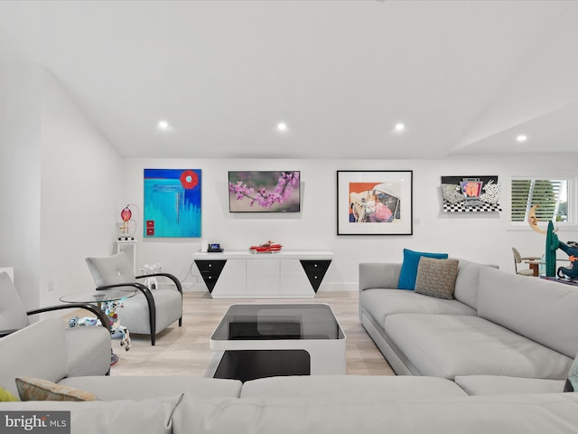 living room with lofted ceiling, light wood finished floors, and recessed lighting