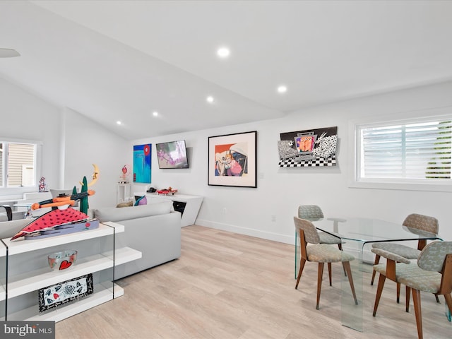 interior space featuring recessed lighting, vaulted ceiling, light wood-style flooring, and baseboards