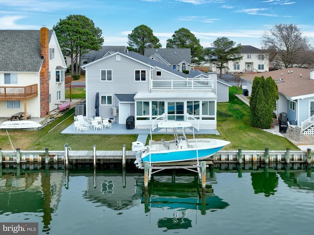 back of house featuring a sunroom, a water view, a residential view, and central air condition unit