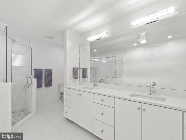 full bath with a sink, a shower stall, and double vanity