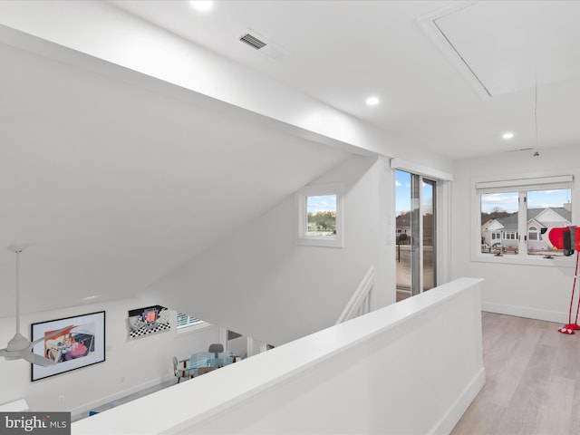 hallway featuring recessed lighting, an upstairs landing, vaulted ceiling, light wood finished floors, and attic access