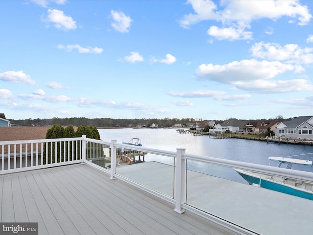 dock area featuring a water view and a residential view