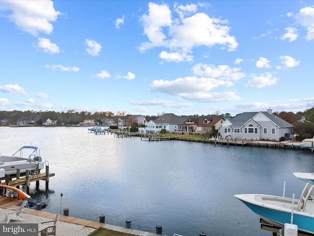 dock area with a residential view, a water view, and boat lift