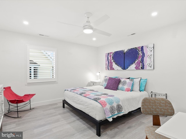 bedroom with recessed lighting, visible vents, baseboards, and wood finished floors