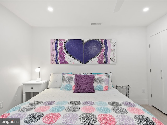 bedroom featuring visible vents, wood finished floors, and recessed lighting