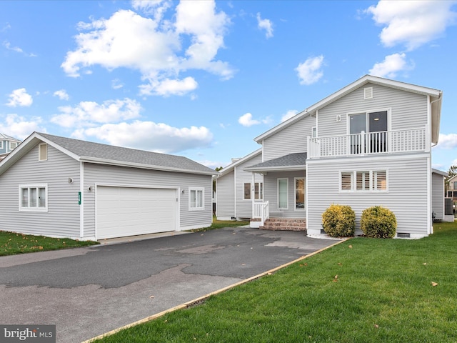 view of front of property featuring a garage, roof with shingles, a balcony, and a front lawn