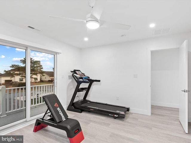 workout room featuring visible vents, ceiling fan, baseboards, and wood finished floors