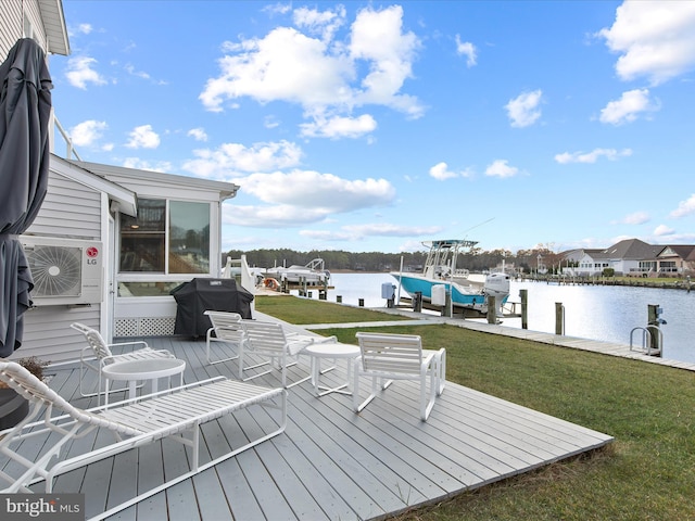 wooden terrace with boat lift, area for grilling, a water view, a yard, and a dock