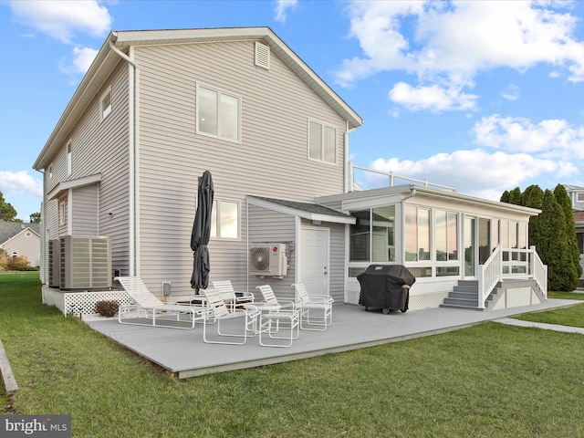 back of property featuring a patio, a yard, ac unit, and a sunroom