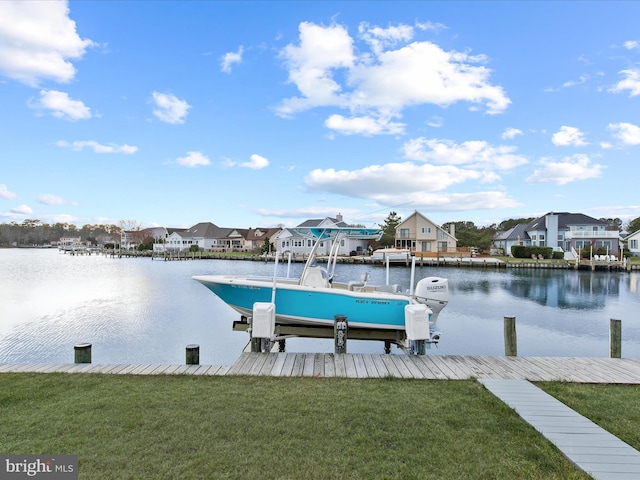 dock area with a lawn, a water view, boat lift, and a residential view