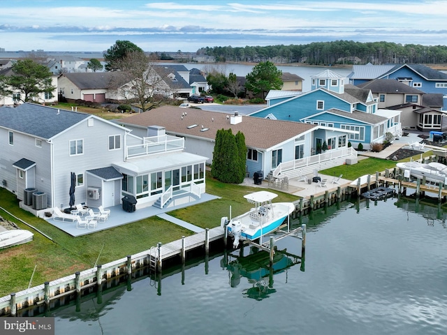 bird's eye view featuring a water view and a residential view