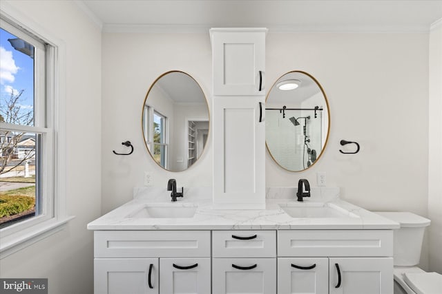 full bath featuring toilet, crown molding, and a sink