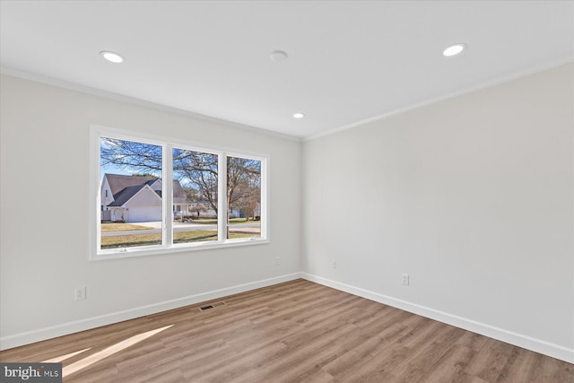 unfurnished room featuring baseboards, ornamental molding, wood finished floors, and recessed lighting