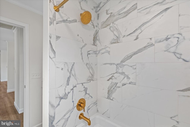 full bathroom with shower / bath combination, baseboards, visible vents, wood finished floors, and crown molding