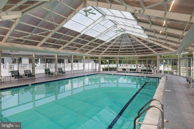 community pool with a patio area and fence