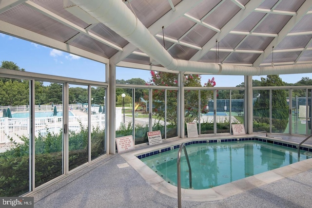 community pool featuring a patio area and fence