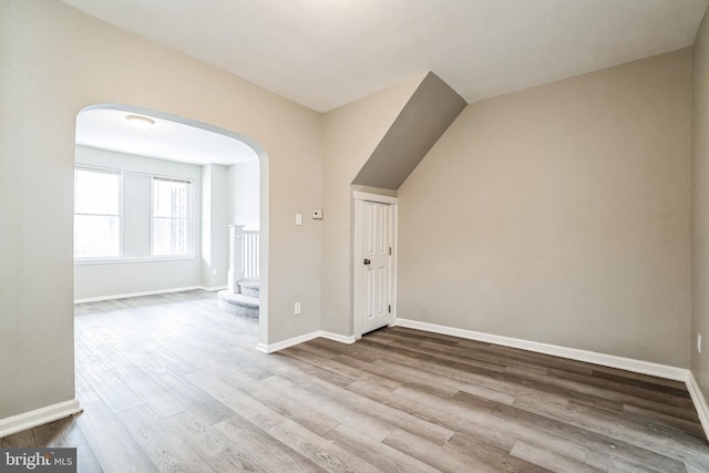 5717 Addison St, Philadelphia, PA 19143 - bonus room featuring arched walkways, wood finished floors, baseboards, and stairway