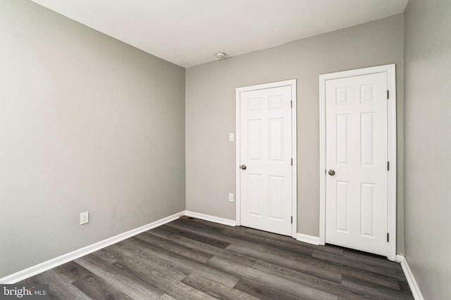 5717 Addison St, Philadelphia, PA 19143 - unfurnished bedroom featuring dark wood finished floors and baseboards