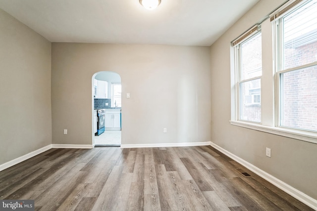 5717 Addison St, Philadelphia, PA 19143 - spare room with wood finished floors, arched walkways, baseboards, and a sink
