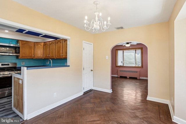 kitchen featuring arched walkways, brown cabinets, visible vents, radiator heating unit, and appliances with stainless steel finishes