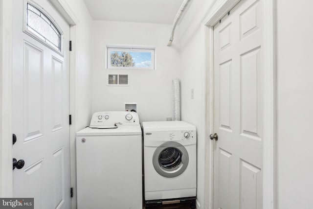 clothes washing area featuring laundry area, visible vents, and separate washer and dryer