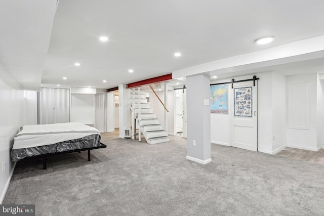 carpeted bedroom with a barn door, baseboards, and recessed lighting