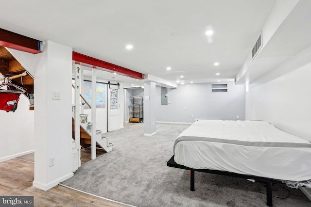 bedroom featuring baseboards, visible vents, wood finished floors, and recessed lighting