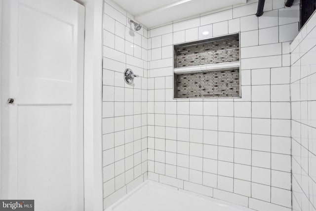 bathroom with a tile shower