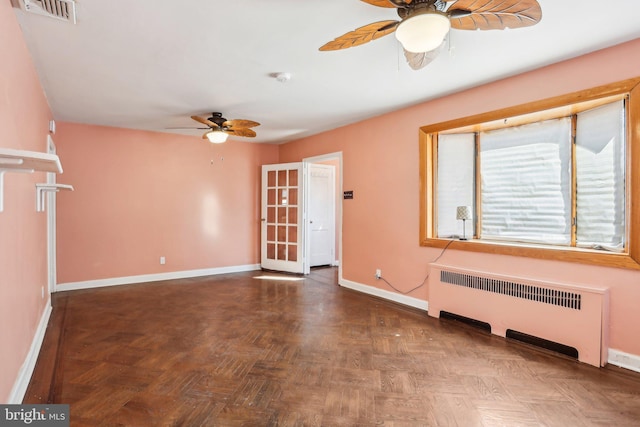 unfurnished living room with radiator, baseboards, visible vents, and a ceiling fan