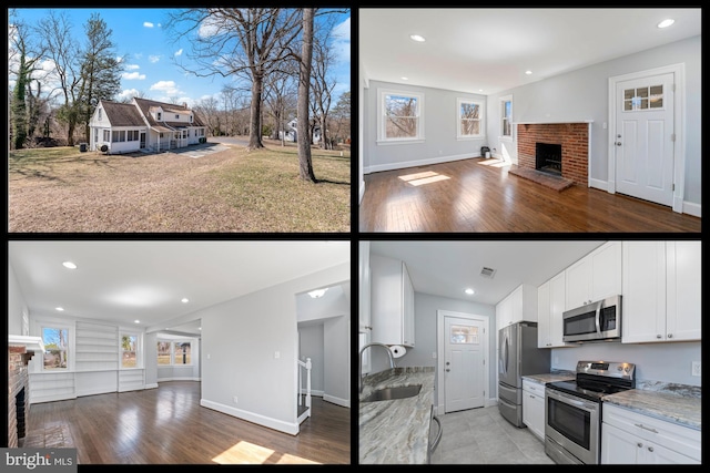 kitchen with a sink, stainless steel appliances, light wood-style floors, a brick fireplace, and open floor plan